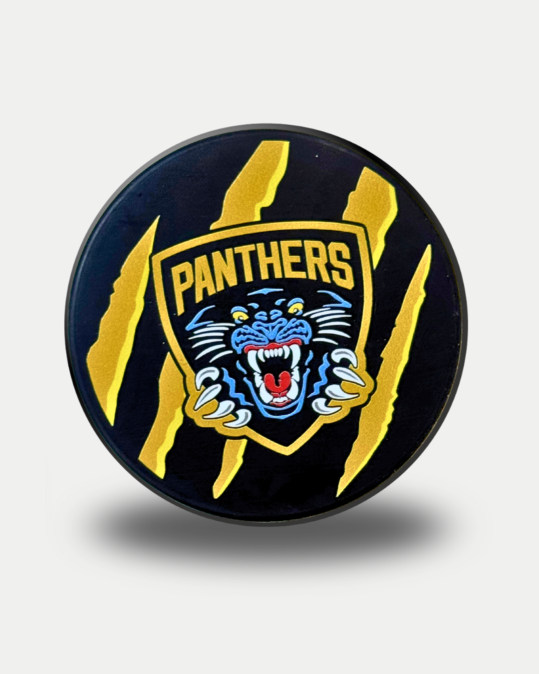 The Panthersland Nottingham Panthers 25-26 Gold Claw Puck is a black puck featuring a yellow and black shield with a roaring blue panther, "PANTHERS" text, and three gold claw marks on a plain background.