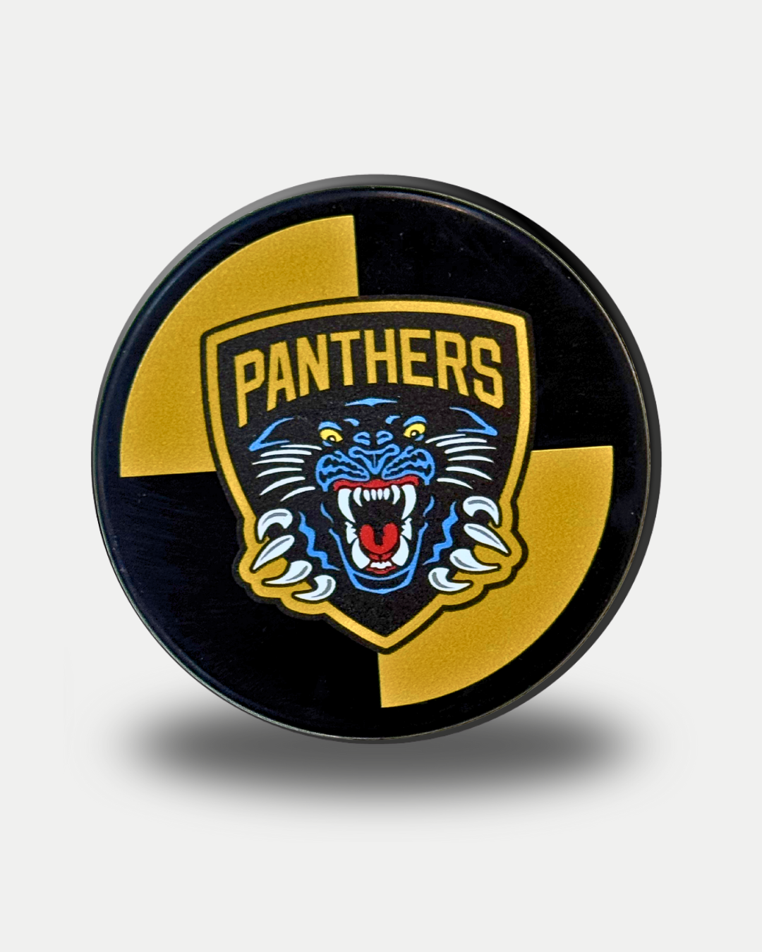 The Panthersland Nottingham Panthers 25-26 Quad Puck features a fierce blue panther head with an open mouth on a yellow and black background, outlined by a yellow shield and the iconic PANTHERS logo.
