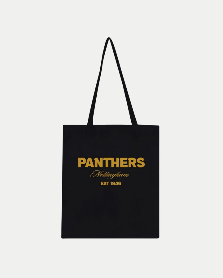 The Nottingham Panthers Made-To-Order Panthers Est 1946 Tote Bag in black features gold “PANTHERS Nottingham EST 1946” print, a minimalist eco-friendly design, and long handles. Branding and details shown on a plain white background.