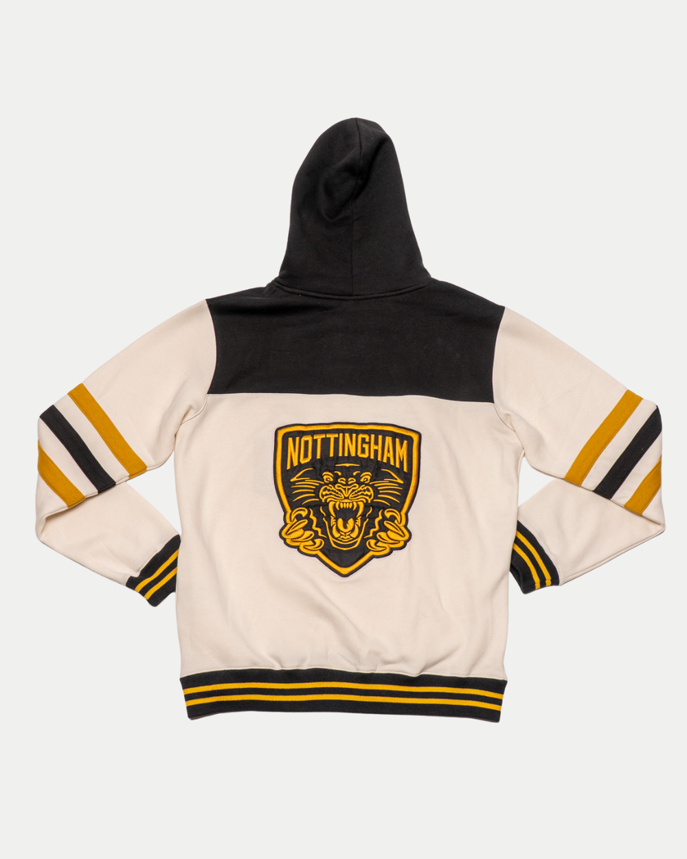 The Nottingham Panthers 25-26 Off White Script Hoodie by Panthersland features cream sleeves, black and yellow striped cuffs, a large Nottingham Panthers patch above a roaring tiger on the back, and a black hood and shoulders—a fan favourite.