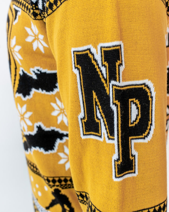 A close-up of the Panthersland "Panthers Christmas Jumper 2025 Have An Ice Christmas" in yellow, with black and white snowflakes, bat motifs, and a bold NP patch—perfect festive wear for dedicated Panthers fans.