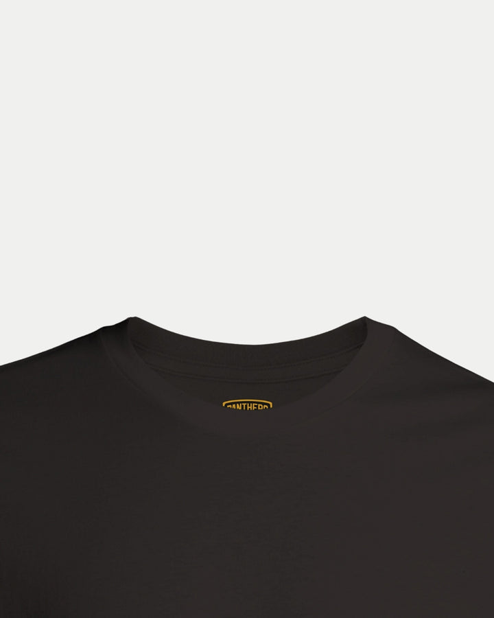 The Made To Order NP 2025 Playoff Champions T-shirt Black by Nottingham Panthers is shown on a white background, highlighting the neckline and upper chest with a small, partially visible yellow tag inside the collar.