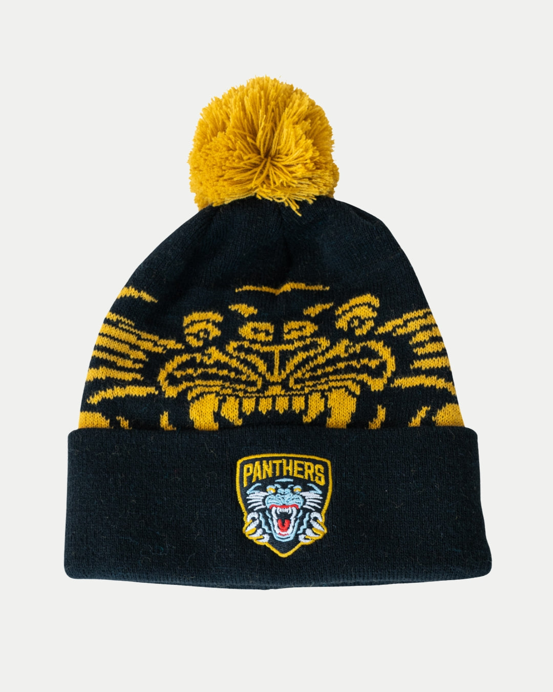 The Panthersland Nottingham Panthers 25-26 Beanie Gold POM is a black knit beanie with a yellow pom-pom, yellow tiger face design, and a “Panthers” logo patch with roaring tiger on the front cuff for the 2025-2026 season.