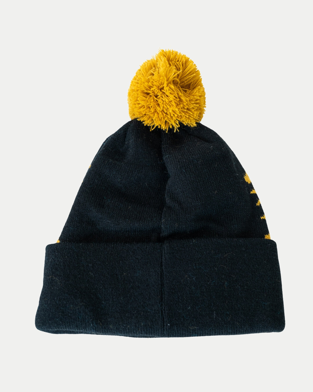 The Panthersland Nottingham Panthers 25-26 Beanie Gold POM is a black knit beanie with a folded brim and large yellow pom-pom, perfect for the 2025-2026 season, shown on a plain white background.