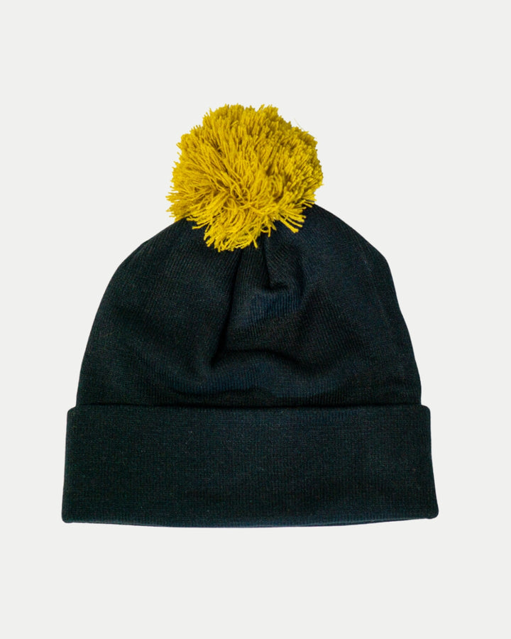 The Nottingham Panthers 25-26 Charcoal Crest Pom Knit by Panthersland features a folded brim and a large yellow pom-pom, shown on a plain white background.