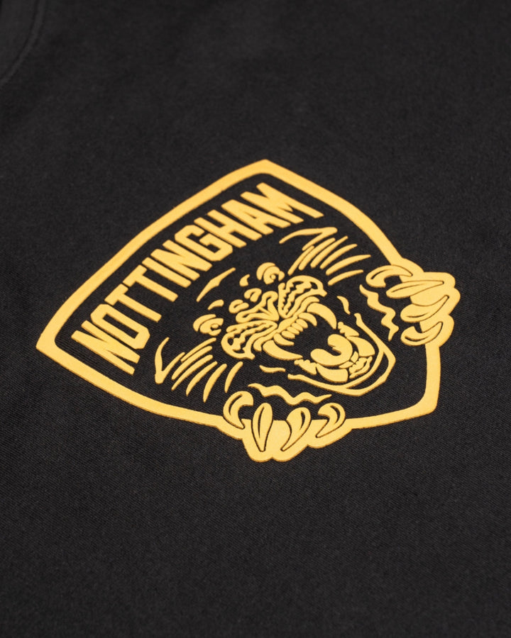 The Panthersland Nottingham Panthers 25-26 Junior Black Big Backprint T-Shirt features a bold yellow shield emblem, NOTTINGHAM, and a roaring panther—an ideal addition to any kids t-shirt collection.