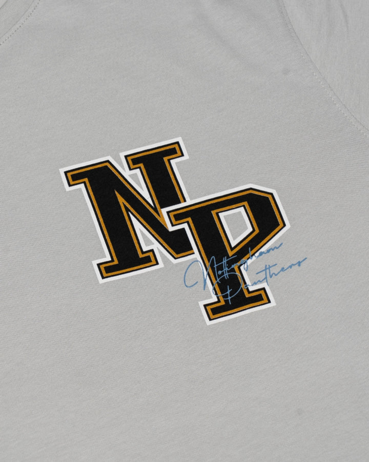 The Panthersland Nottingham Panthers 25-26 Junior Grey NP Logo T-Shirt features bold black and gold outlined “NP” letters and a small blue signature, perfect for young fans to show their team pride.