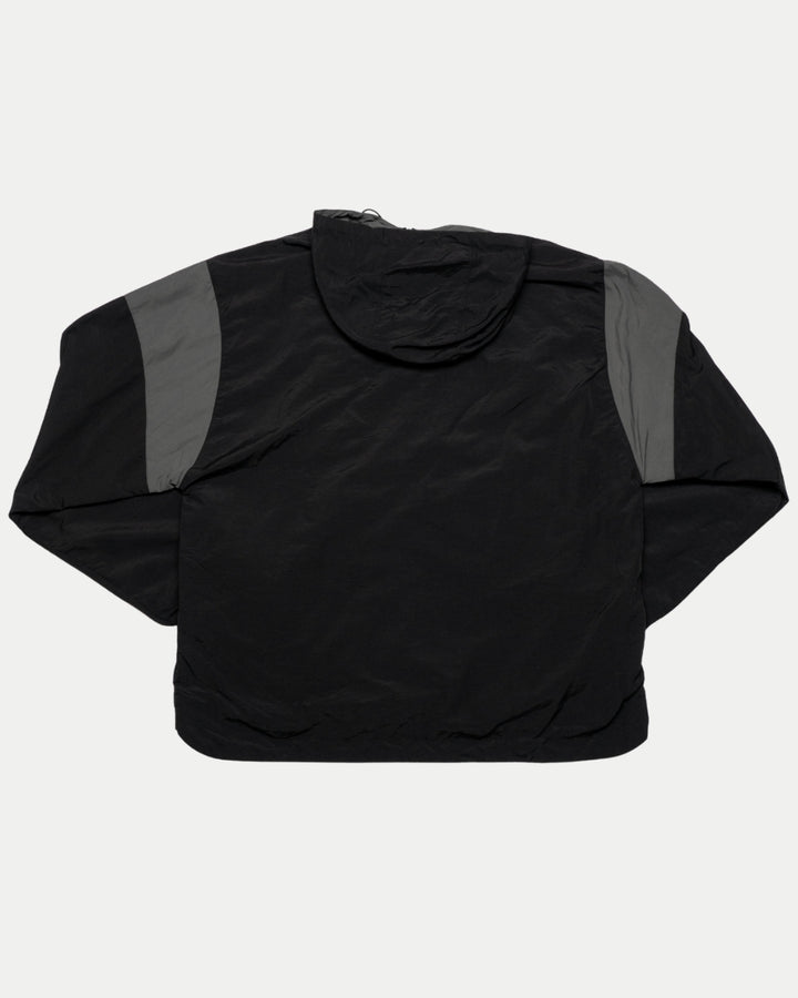 The Panthersland Nottingham Panthers 25-26 Black Anorak features dark gray shoulder panels, a hood, and a water-resistant finish—perfect for fans facing unpredictable weather. Shown flat with the back up.