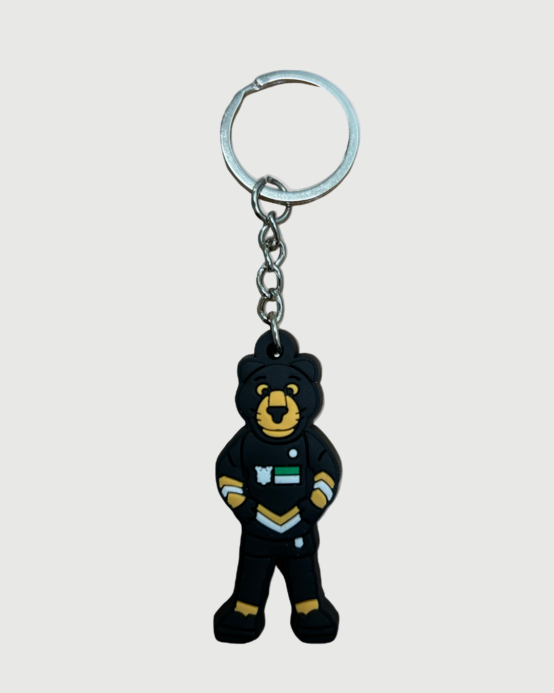 The Panthersland Paws Keyring is a fun accessory featuring a cartoon bear mascot in a black sports uniform with light blue and white accents, standing confidently with hands on hips.