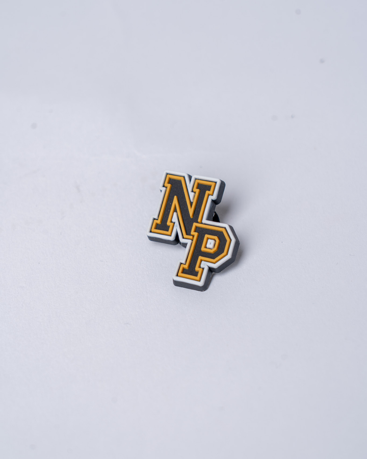 The Panthersland Nottingham Panthers 25-26 NP Croc Charm features bold yellow uppercase NP letters outlined in black and white, set against a plain light gray background.