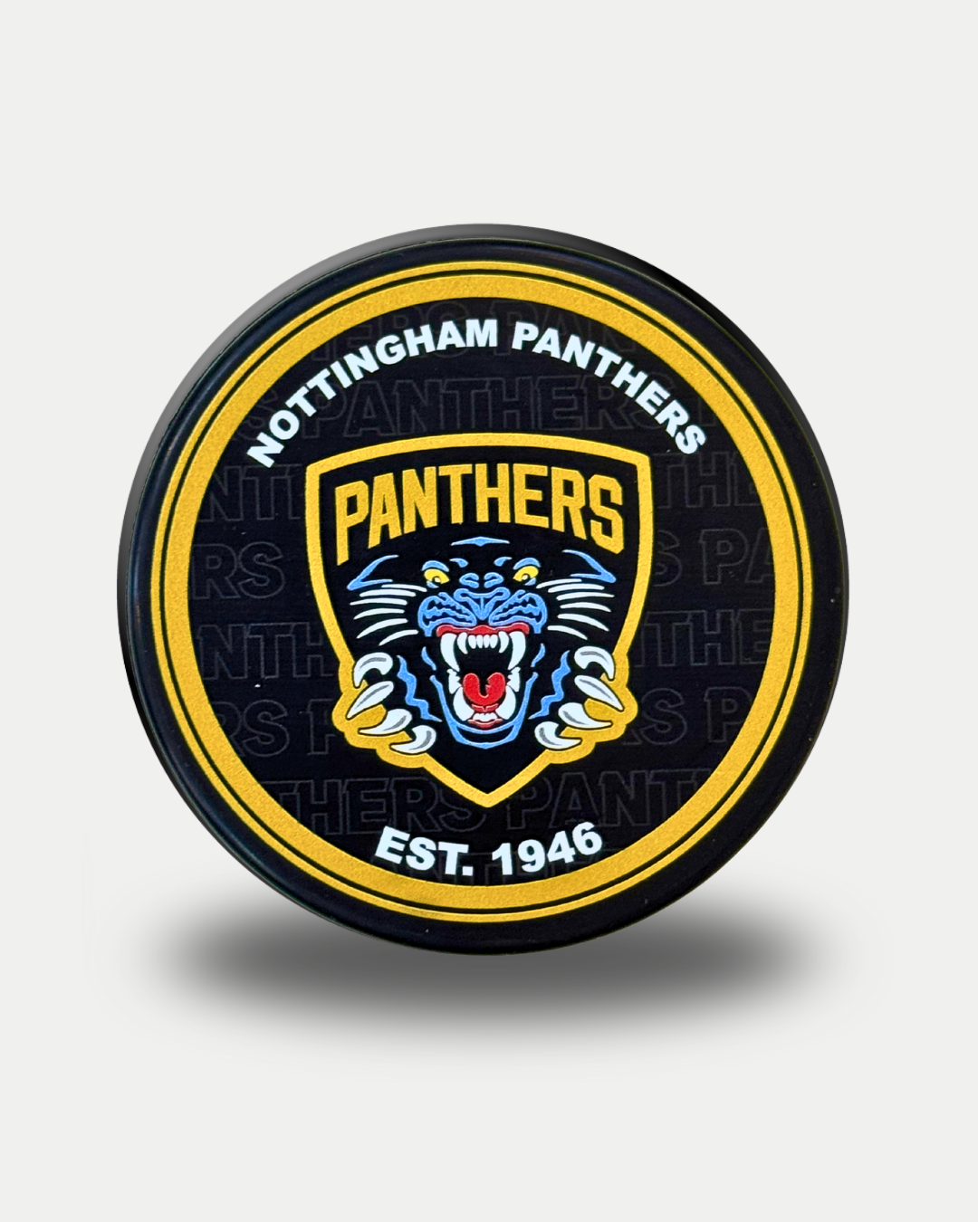 The Panthersland Nottingham Panthers 25-26 1946 Puck is black and displays a blue and yellow roaring panther head, encircled by "NOTTINGHAM PANTHERS EST. 1946.