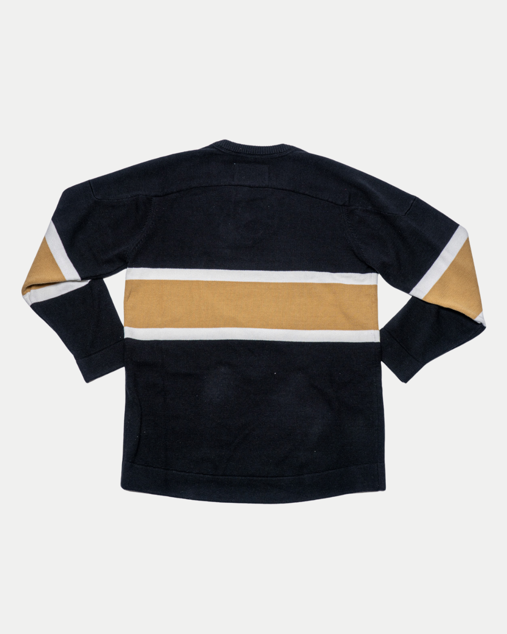 The Nottingham Panthers 25-26 CCM Gold Heritage Sweater by Panthersland features long sleeves and a wide gold stripe with narrower white stripes, shown flat with the back facing up.