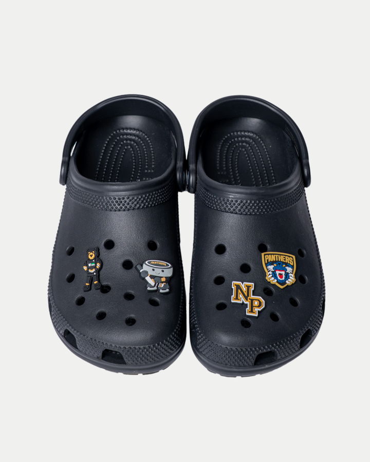 A pair of black Panthersland clogs with four Nottingham Panthers 25-26 NP Croc Charms—a bear mascot, a robot, an NP monogram, and a Panthers badge—displayed side by side on a white background.