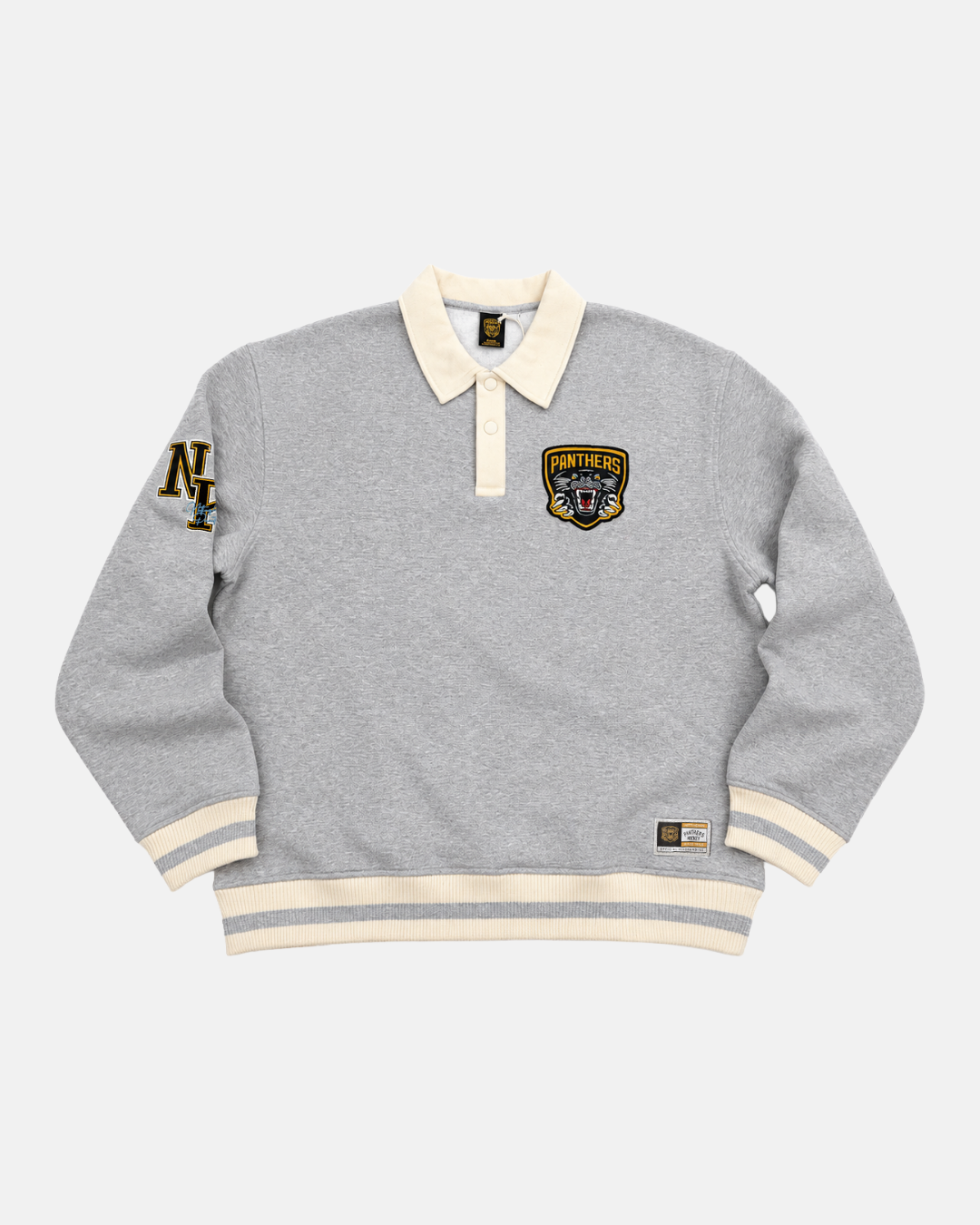 The Panthersland 26-27 Grey Crest Sweater is a light gray long-sleeve rugby-style sweater featuring a cream collar and cuffs, the iconic Panthers crest on the chest, N and T letters on the left sleeve, and a small rectangular label near the hem for classic appeal.