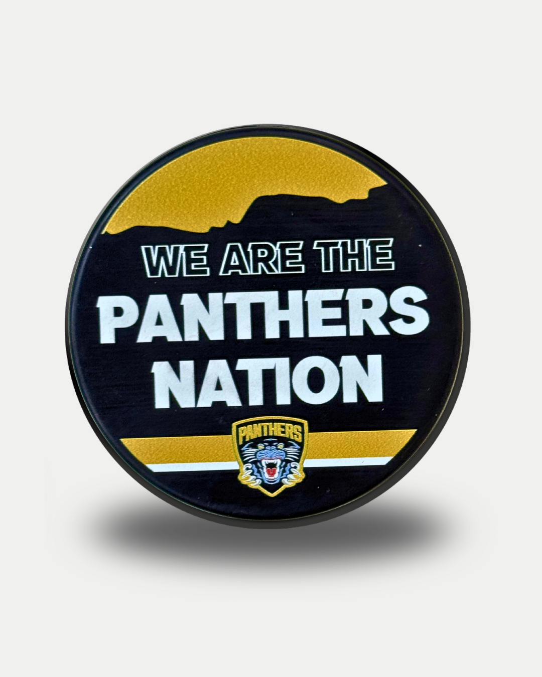 The Nottingham Panthers 25-26 Nation Puck by Panthersland features bold "We Are The Panthers Nation" text, a small tiger logo at the bottom, all set on a black and gold background.