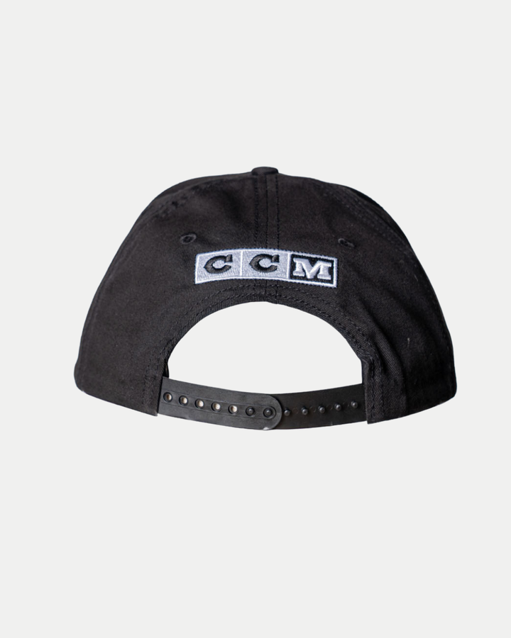The Nottingham Panthers 25-26 CCM Black Flatbrim Snapback by Panthersland is shown from the back, featuring an adjustable snapback strap and a stitched white CCM logo patch above the opening.