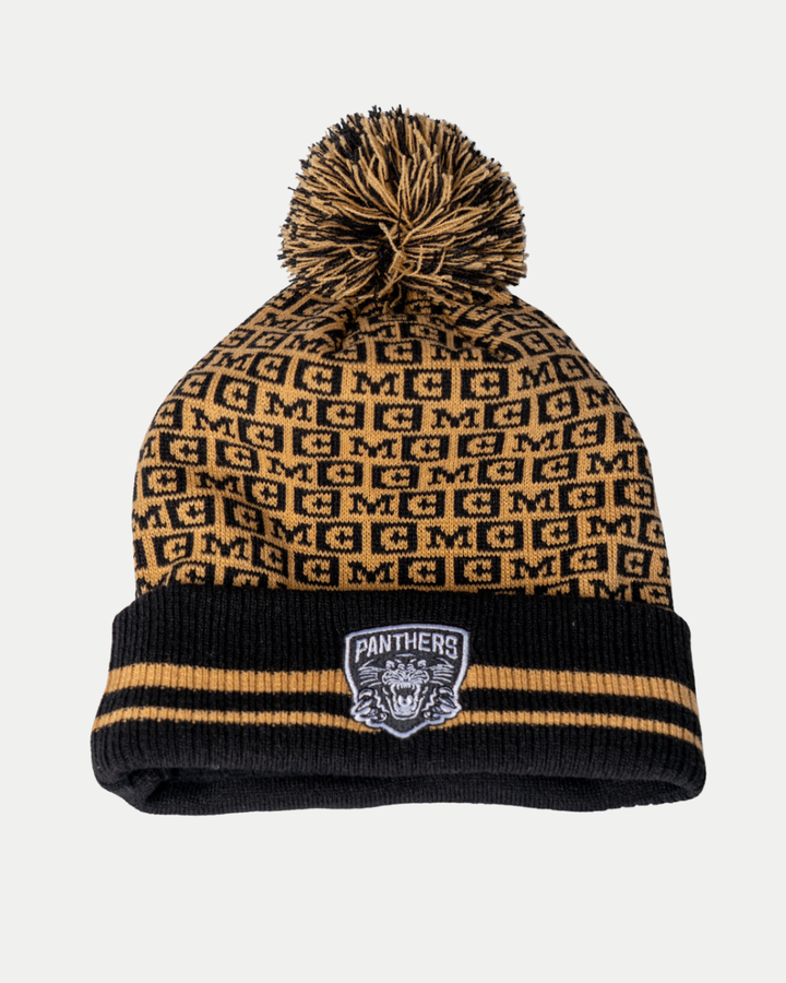 The Nottingham Panthers 25-26 CCM Black Crest Pom Knit by Panthersland features a black and gold design with a pom-pom, repeating “M” pattern, black cuff with gold stripes, and a Panthers patch on the front.