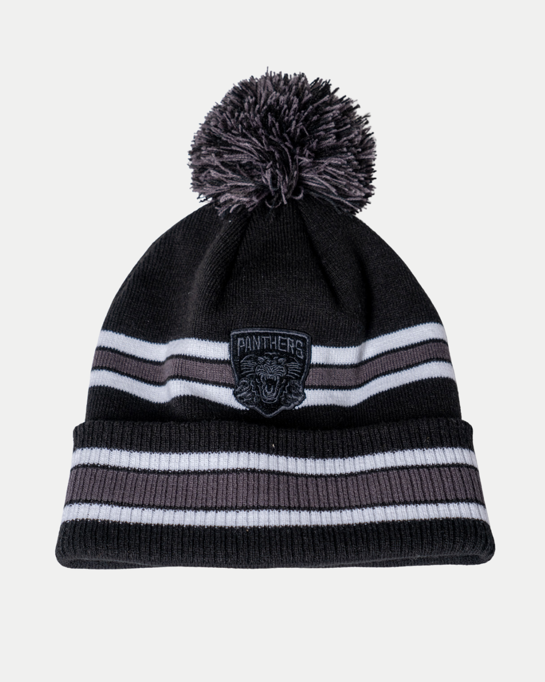 The Panthersland Nottingham Panthers 25-26 CCM White Stripe Pom Knit is a black beanie with white and gray stripes, a pom-pom, and a cuff patch displaying a panther logo and "Panthers".