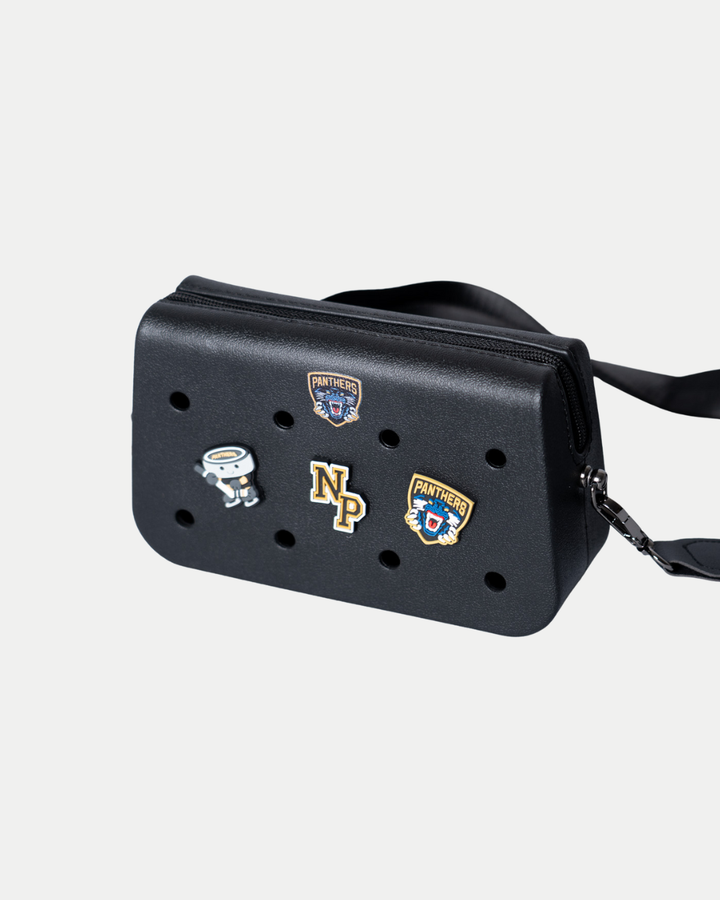 The Panthersland Nottingham Panthers Croc Charm Bag is a black crossbody with a shoulder strap, front perforations, and pins including two Panthers badges, an astronaut, and an NP logo.