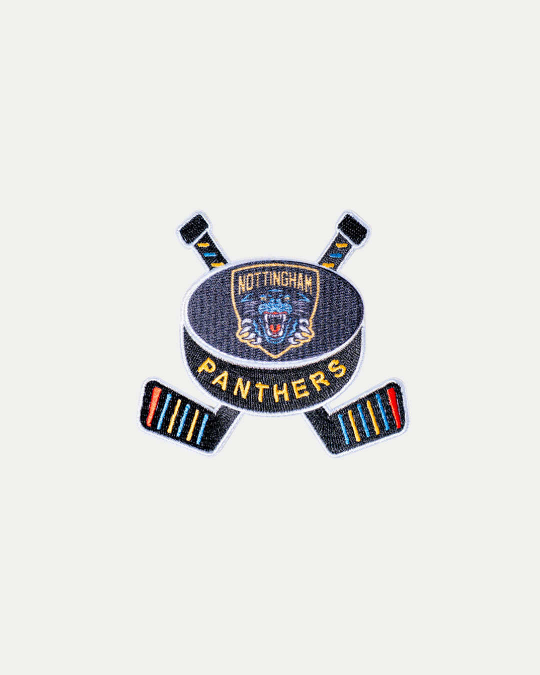 The Panthersland Nottingham Panthers Stick Patch features two crossed hockey sticks, a puck with team text, and a panther head logo, all in blue, gold, red, and black embroidery.