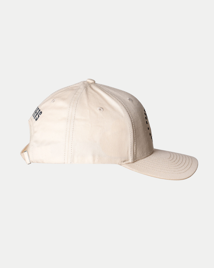 The Nottingham Panthers 25-26 CCM Cream Adjustable Cap by Panthersland is shown from the side with stitched panels, ventilation eyelets, a curved brim, and an adjustable back strap against a plain white background.