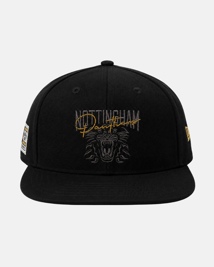 The Panthersland 26-27 Signature Snapback Cap is a black cap featuring Nottingham Panthers text and a bold crest logo embroidered on the front, with a New Era logo on the side and a sticker on the brim.