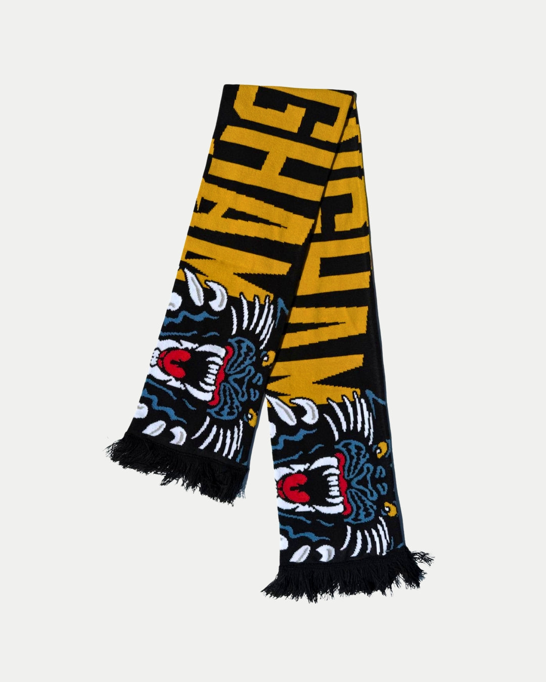The Panthersland 25-26 Big City Text Scarf features bold black and yellow colors, capital lettering, fierce tiger graphics with red, white, and blue accents at each end, and is finished with classic black fringe.