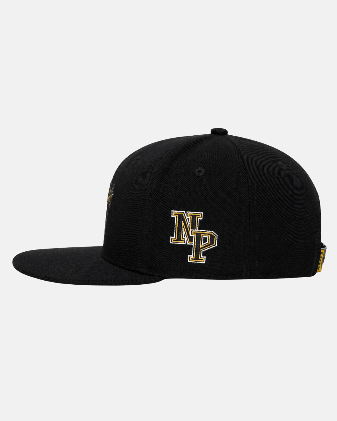 Panthersland 26-27 Signature Snapback Cap in black, featuring gold and white NP lettering embroidered on the side. Shown from the right side against a plain light background—a stylish tribute to the Nottingham Panthers.