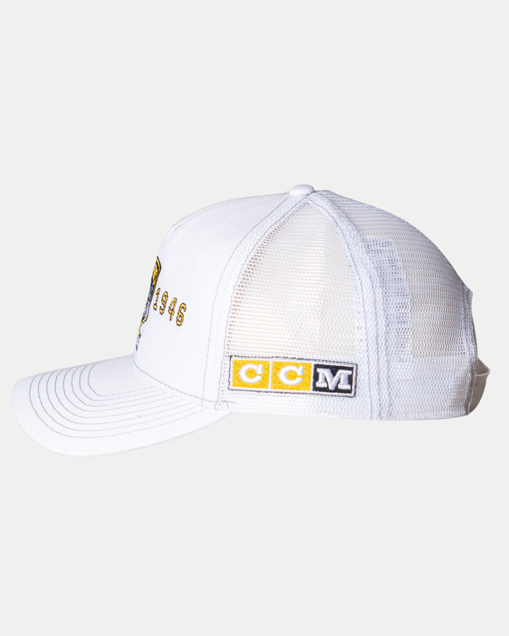 The Nottingham Panthers 25-26 CCM White Mesh Back Trucker by Panthersland is shown from the side, featuring a yellow and black CCM logo patch on the back panel and partial embroidered text and numbers on the front.