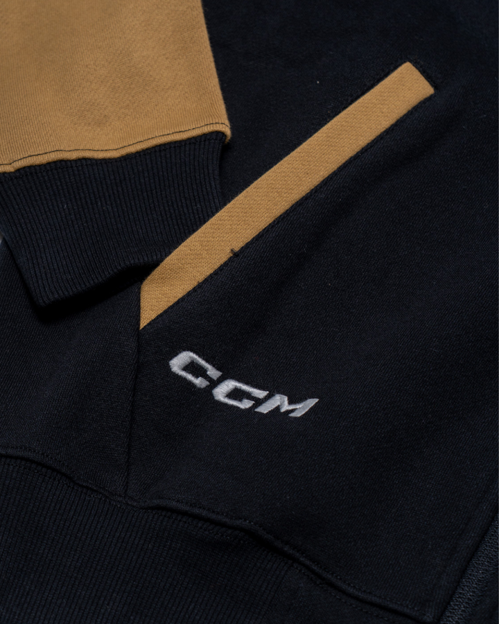 Close-up of the Nottingham Panthers 25-26 CCM Track Jacket by Panthersland, featuring tan pocket and sleeve accents on a dark base. "CGM" is embroidered in white near the pocket.