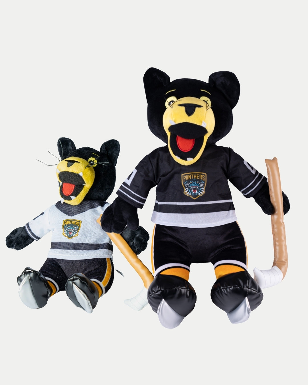 The Paws Plush Bundle by Nottingham Panthers features two plush mascots in team jerseys—one larger black Big Paws Plushie and one smaller Paws White Jersey Plushie—each holding a plush hockey stick.