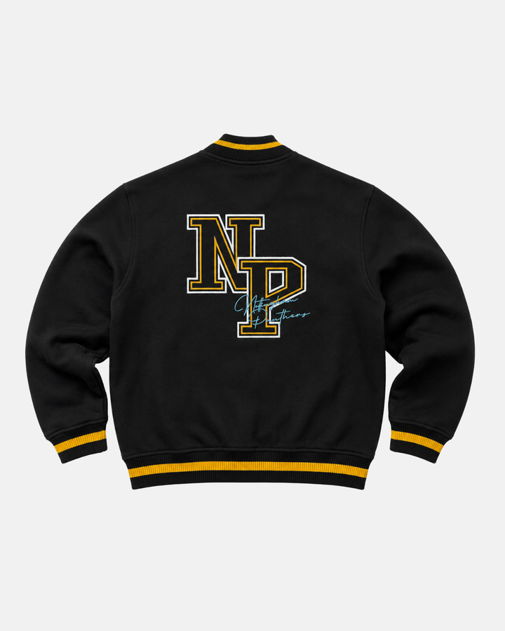 The Panthersland 26-27 NP Varsity Sweater is a black varsity jacket with yellow striped cuffs and collar, inspired by classic collegiate fashion, featuring bold yellow NP logo letters on the front and a light blue signature-style graphic on the back.