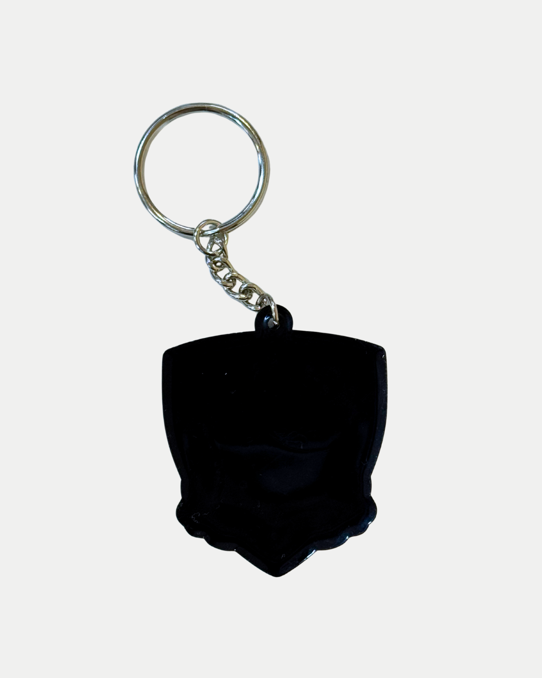 The Panthersland Nottingham Panthers PVC Keyring is a black, shield-shaped keyring with the team crest logo and a silver metal ring, shown on a plain white background.