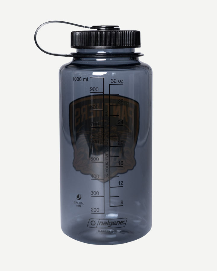 The Panthersland Panthers x Nalgene 1L Water Bottle is translucent gray, BPA-free, with a wide mouth, black screw-on lid, and milliliter/ounce markings. A faded graphic with text shows through the bottle.