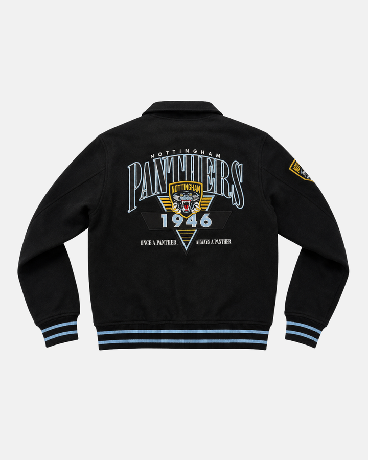 Step into heritage style with the Panthersland 26-27 Vintage Varsity Jacket—a classic black design accented by light blue stripes, showcasing Nottingham Panthers 1946 and Once a Panther, Always a Panther on the back. This jacket features an iconic panther logo patch on the left sleeve and an embroidered Panthers crest, perfectly capturing vintage-inspired flair.