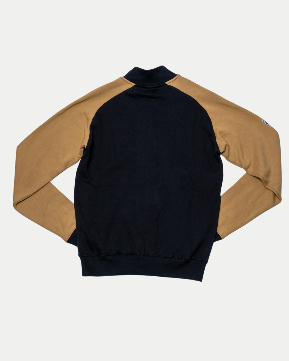 The Nottingham Panthers 25-26 CCM Track Jacket by Panthersland features a black body and tan sleeves, shown flat with the back facing up on a plain white background.