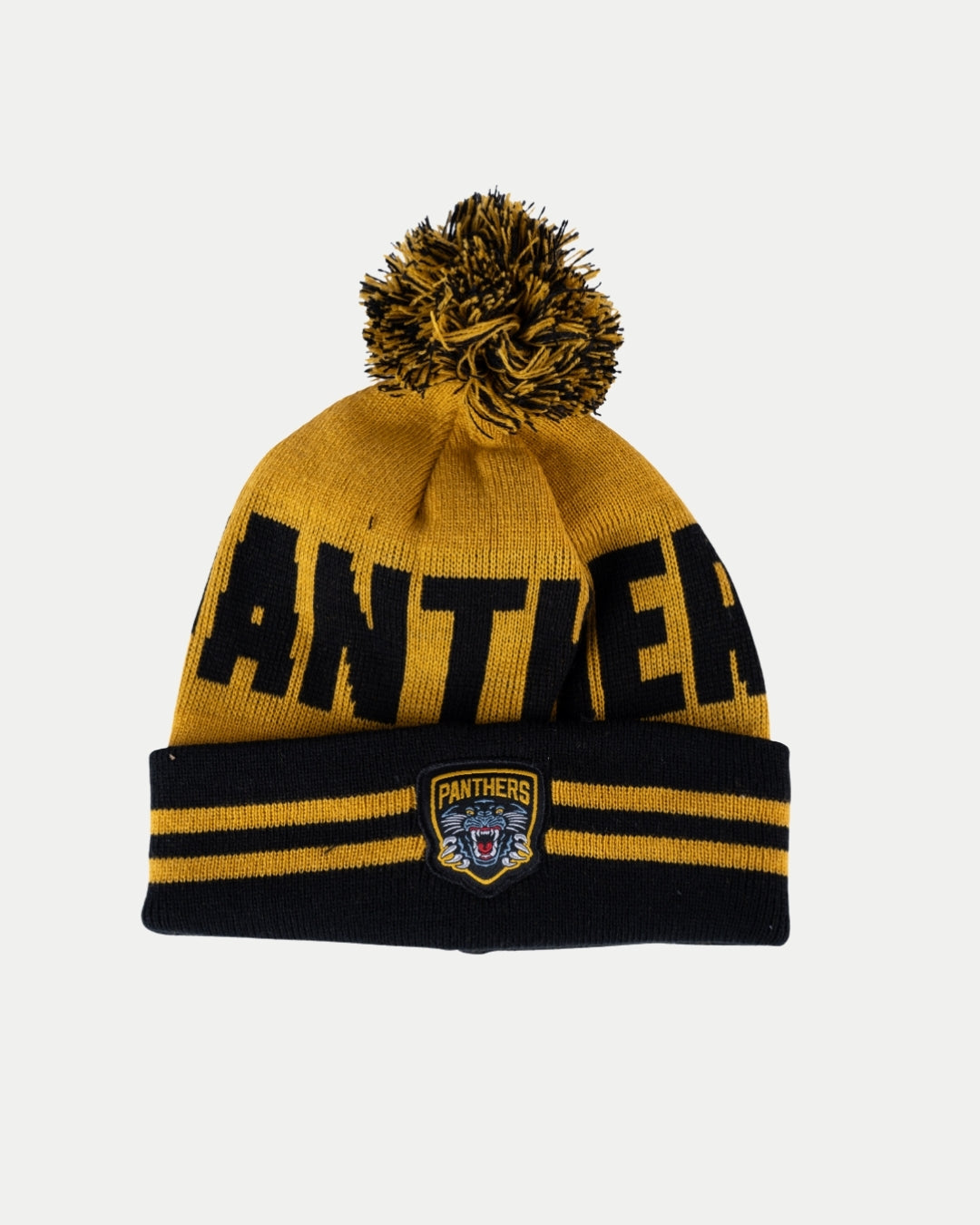 The Nottingham Panthers 24-25 Black Team Pom Knit is a yellow and black beanie with a pom-pom, bold PANTHERS lettering, and an official panther head logo patch on the front cuff.