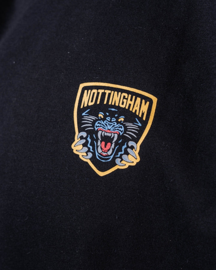 Close-up of The Nottingham Panthers Golden Logo Black Long Sleeve, featuring a printed emblem of a roaring blue panther and Nottingham in bold yellow above the design.