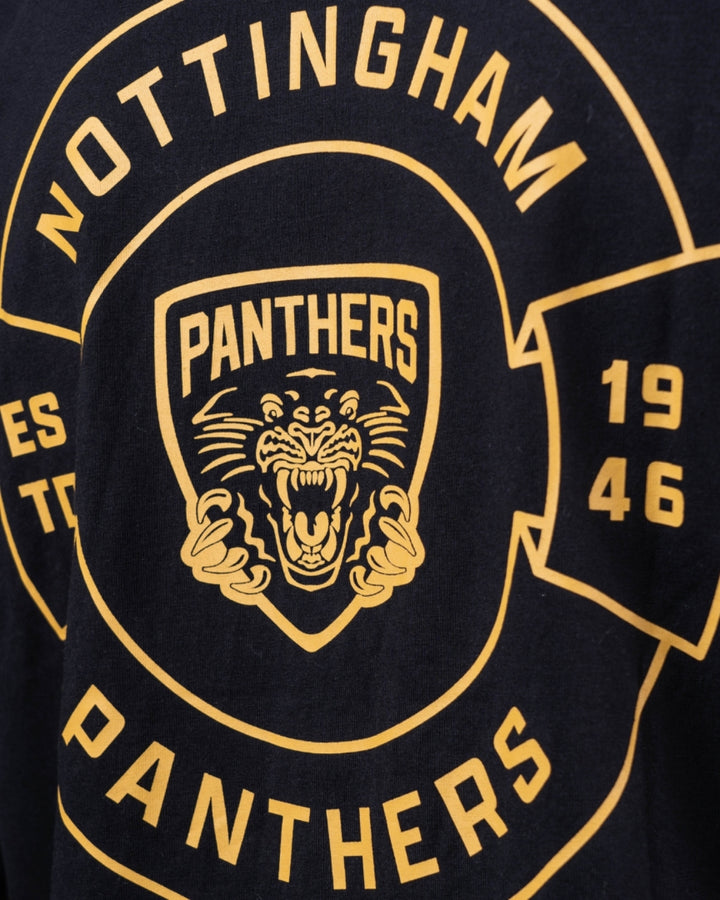 A close-up of The Nottingham Panthers Golden Logo Black Long Sleeve, featuring a yellow roaring panther logo inside a shield and Nottingham Panthers with 1946 accents on black fabric.