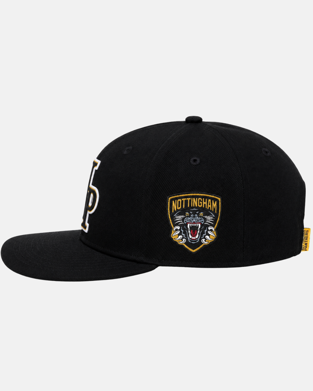 The Panthersland 26-27 NP Logo Snapback is a black flat-brimmed cap featuring an embroidered Nottingham Panthers logo with a roaring panther head and a prominent white letter N on the front, plus a yellow accent tag on the side of the brim.