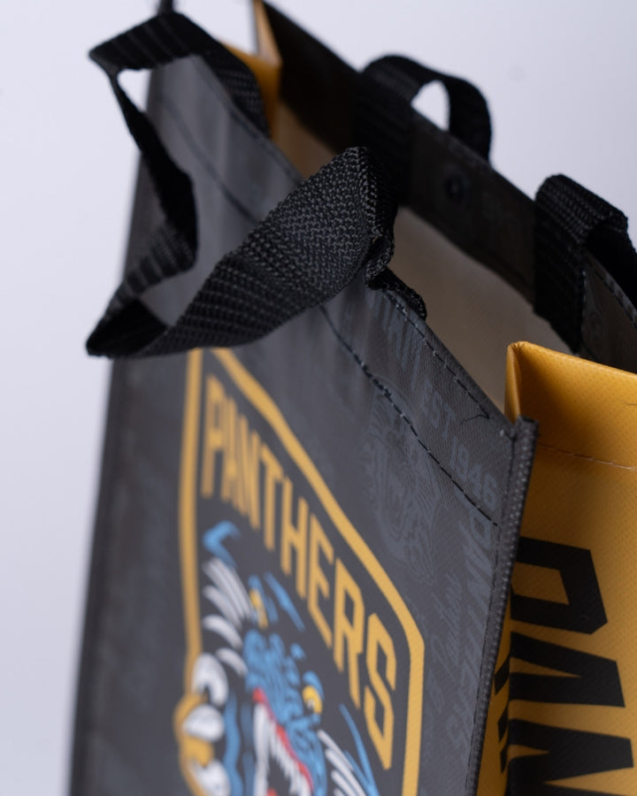 Close-up of The Nottingham Panthers Small Reusable Tote Bag in black and yellow, featuring sturdy handles, PANTHERS in bold yellow letters, and part of a fierce snarling panther graphic.