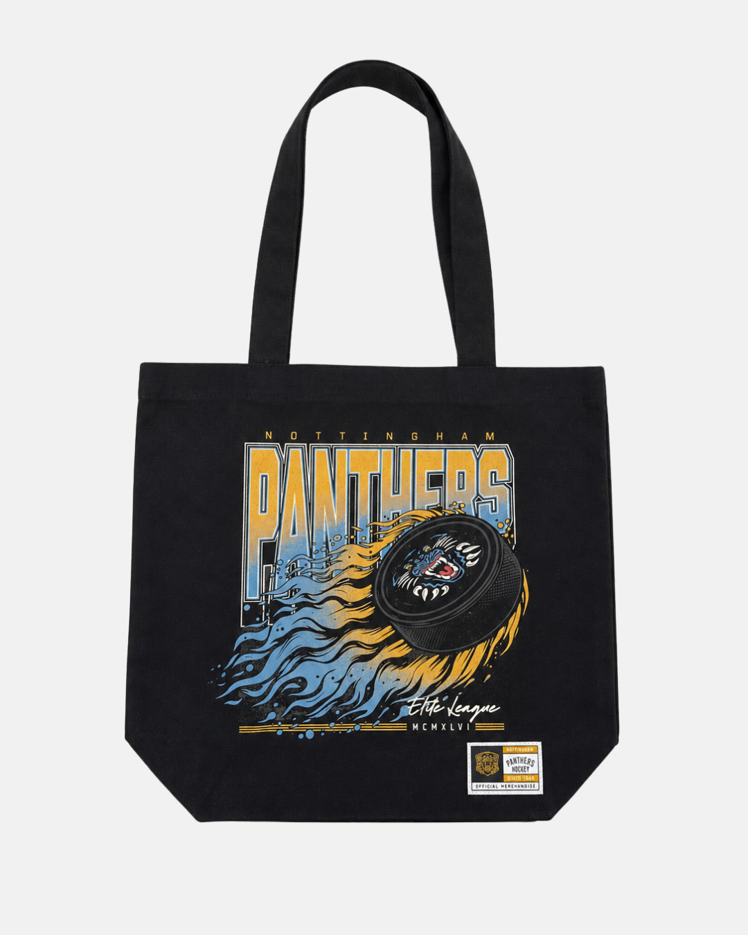 The Panthersland 26-27 Puck Tote Bag is a black canvas tote featuring a flaming hockey puck, NOTTINGHAM PANTHERS text, and a small white patch with gold accents at the bottom corner. This stylish bag is perfect for carrying your essentials to the rink or showing your Nottingham Panthers pride anywhere you go.