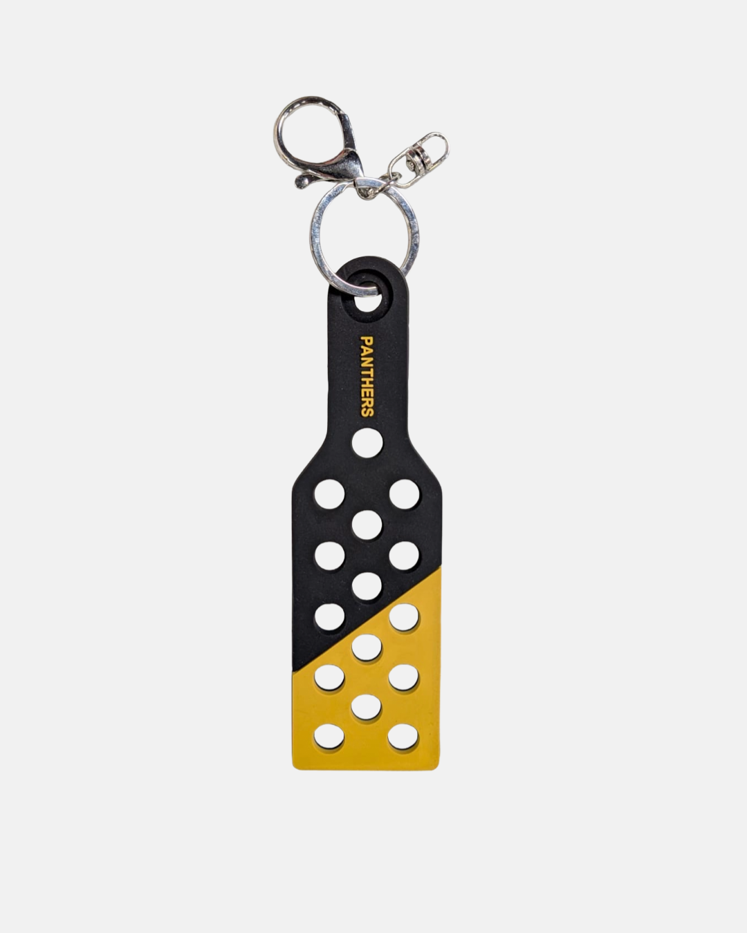 Show your team spirit with the Nottingham Panthers Croc Charm Keyring by Panthersland—a black and yellow paddle-shaped accessory adorned with multiple circular holes and “PANTHERS” printed vertically in white. Perfect for Nottingham Panthers fans, this eye-catching piece can be used as both a unique Croc charm or a stylish keyring.
