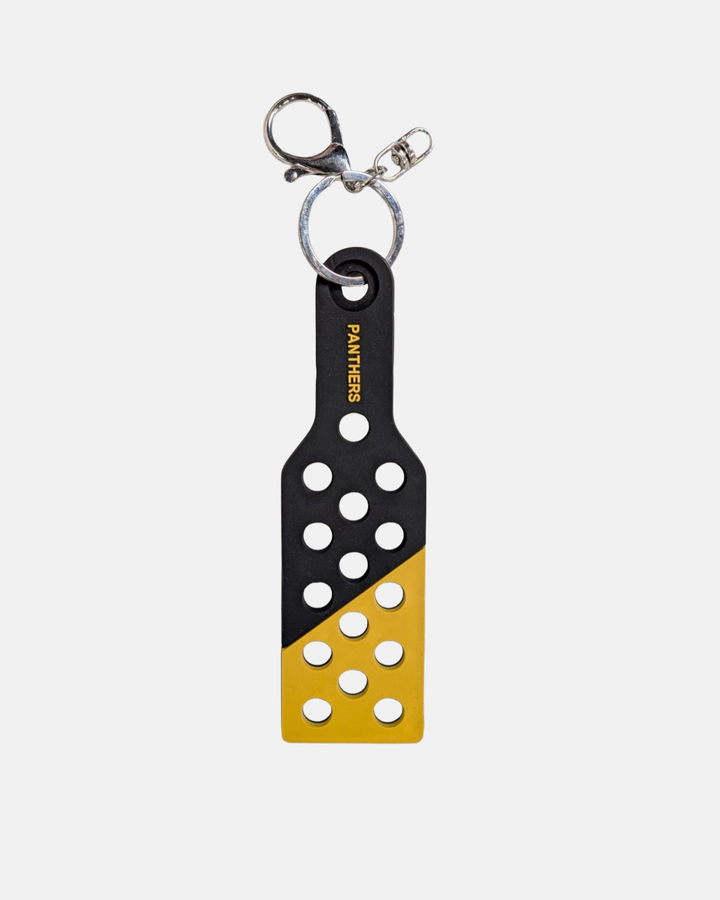 Show your team spirit with the Nottingham Panthers Croc Charm Keyring by Panthersland—a black and yellow paddle-shaped accessory adorned with multiple circular holes and “PANTHERS” printed vertically in white. Perfect for Nottingham Panthers fans, this eye-catching piece can be used as both a unique Croc charm or a stylish keyring.