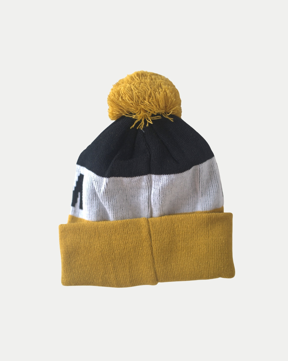 The Nottingham Panthers City Text Pom Knit beanie, featuring a yellow cuff, white middle, black top, and yellow pom-pom, is displayed against a plain white background.