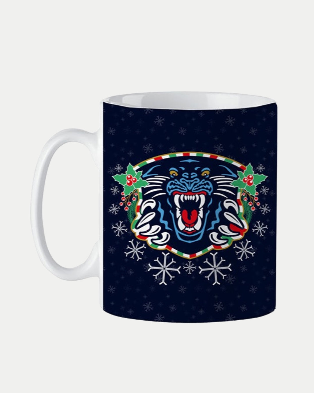 The Nottingham Panthers Christmas Mug by The Nottingham Panthers features a festive white design with a dark blue background, roaring panther logo, holly leaves, berries, and snowflakes—perfect for Christmas or as a stocking filler.