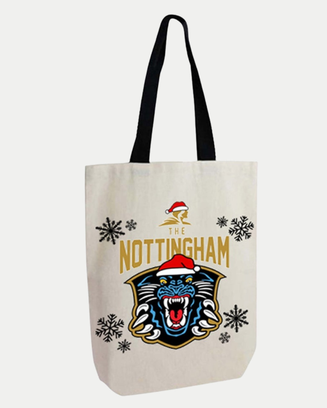 The Nottingham Panthers Christmas Tote Bag is white with black handles, featuring a roaring panther in a Santa hat, The Nottingham text, and bold black snowflake designs.