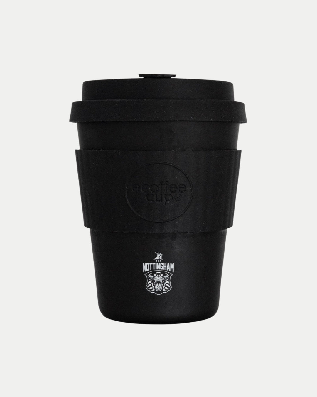 The Panthers Reusable Cup by Nottingham Panthers is a black bamboo fibre coffee cup with a lid and sleeve, featuring the team logo and a stylized face near the bottom. Its simple matte design stands out against a plain white background.