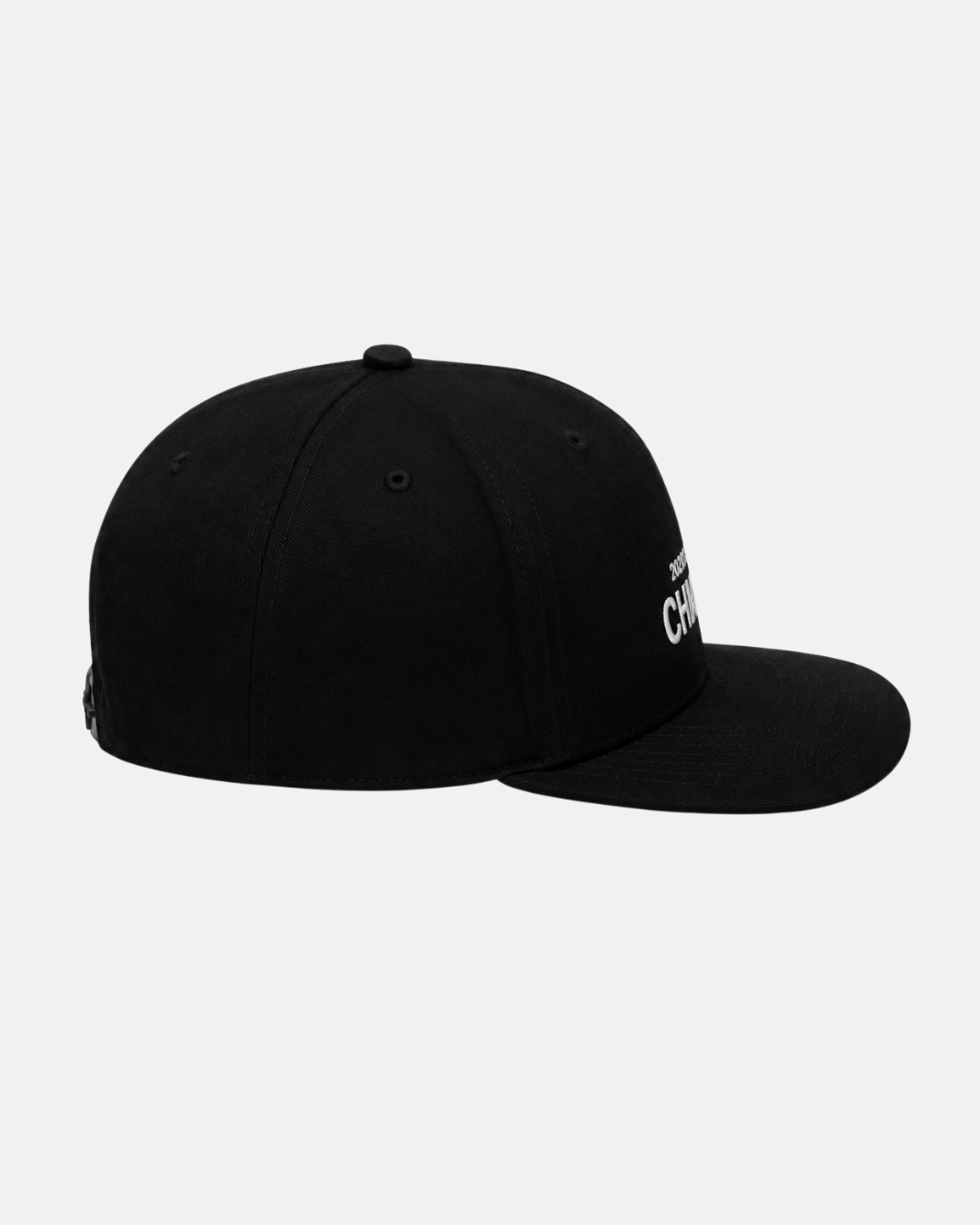 A side view of the Nottingham Panthers 2026 Challenge Cup Champions Retro Snapback Cap by Nottingham Panthers shows its black cotton twill construction with a curved brim and top button. A portion of white logo or text is visible on the front, set against a plain light gray background.