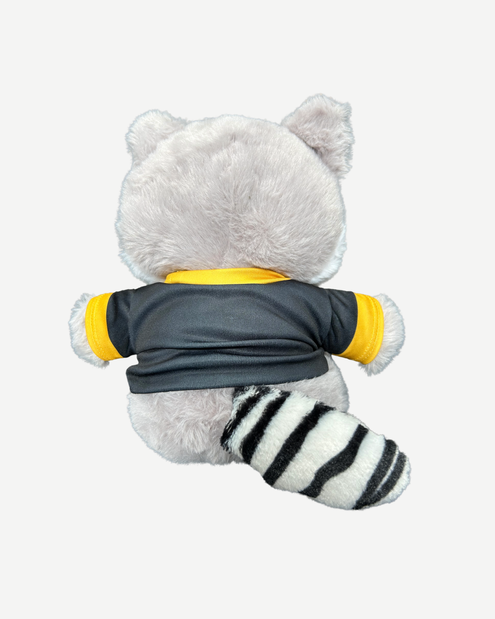 Plush toy raccoon wearing a black and yellow shirt on a white background